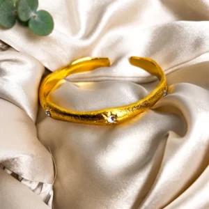 Stone studded gold-plated swirly bangles